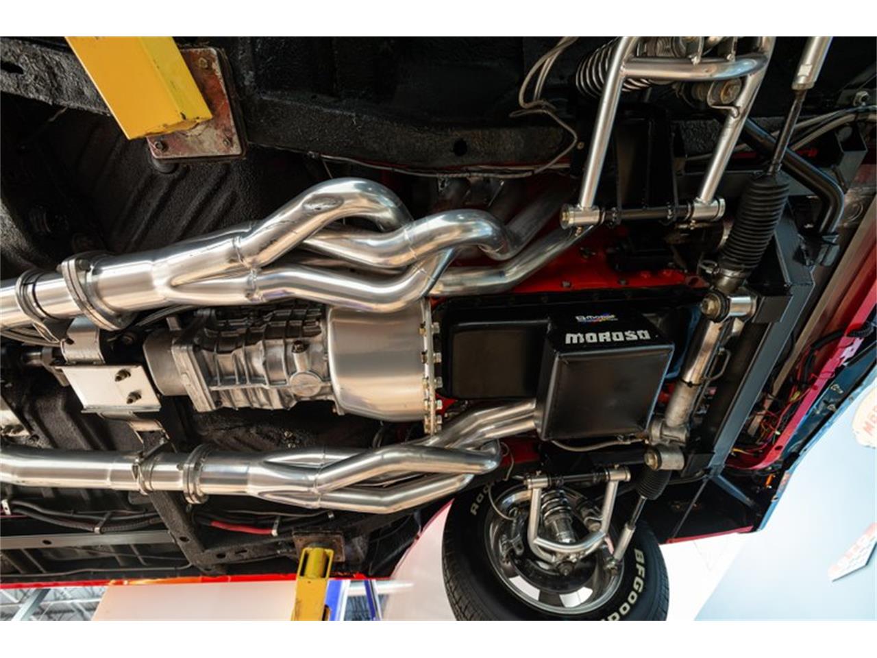 Undercarriage view showing bright coated exhaust components.